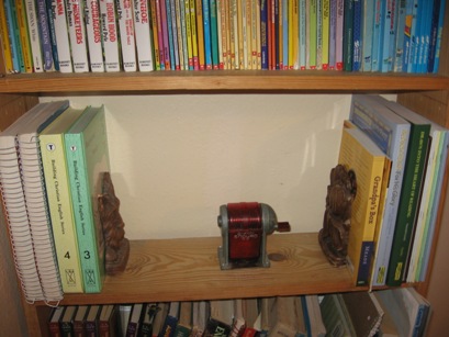 Teacher's Guide's are on a nearby bookshelf. (I know this is a weird place for pencil sharpener, it's the only place I could find that dh would let me drill holes. :)